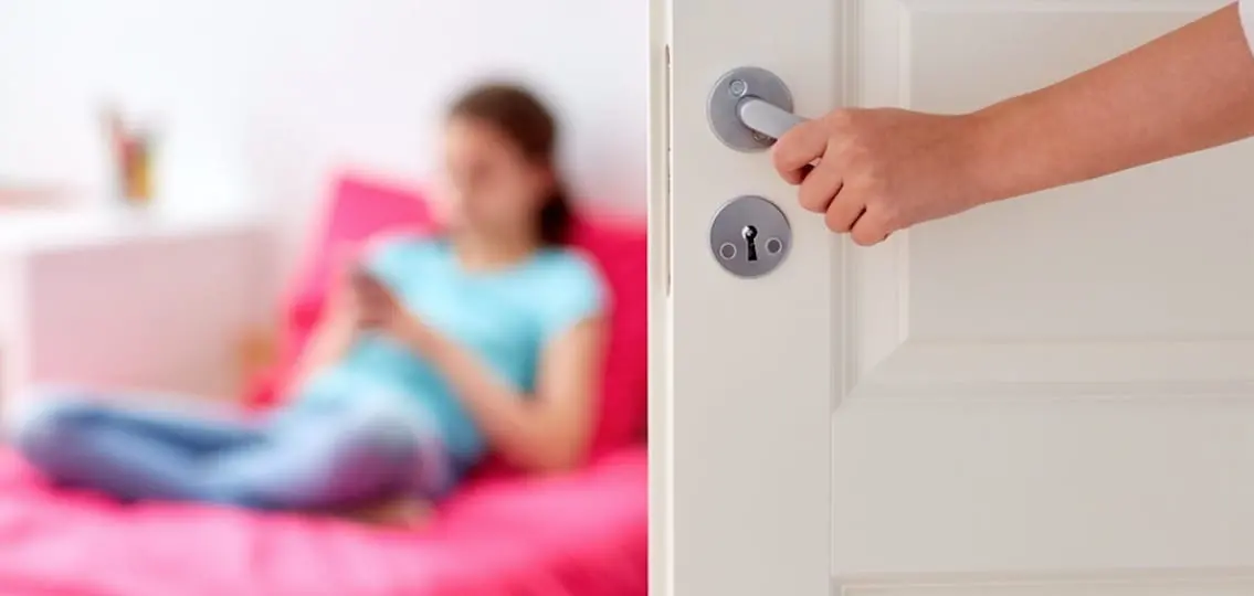 Mother Hand Opening Door To Girl Room teen girl blurred on bed