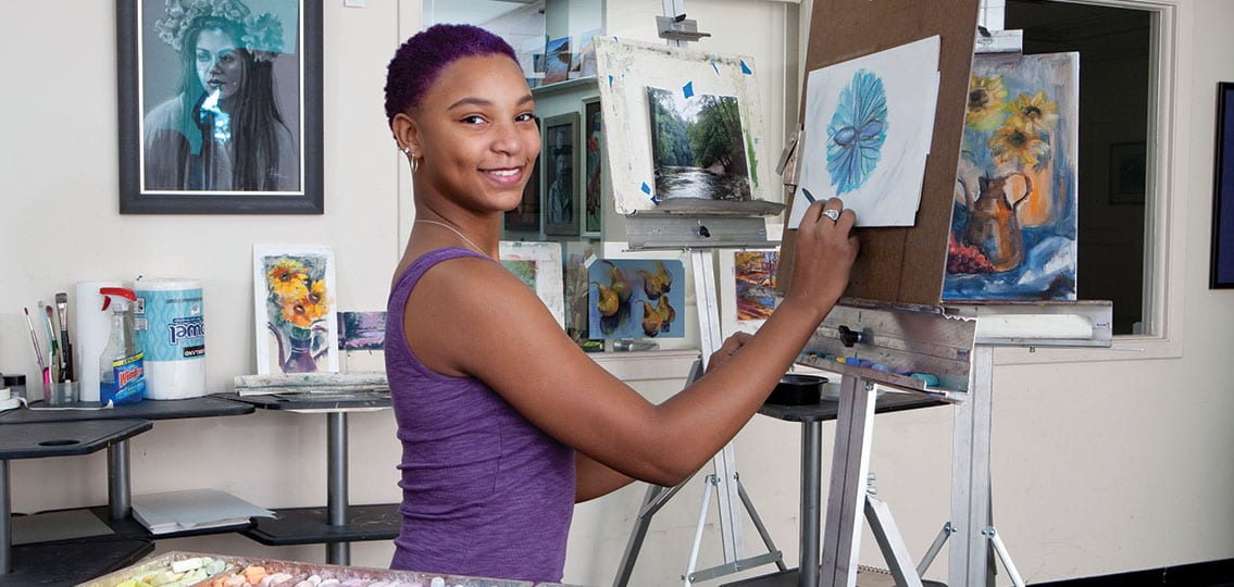 Artist teenage Girl in her Studio Painting