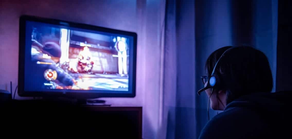 gaming disorder teen boy gaming in the dark at night