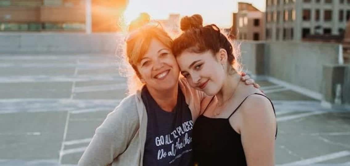 teen girl with her mom on a rooftop