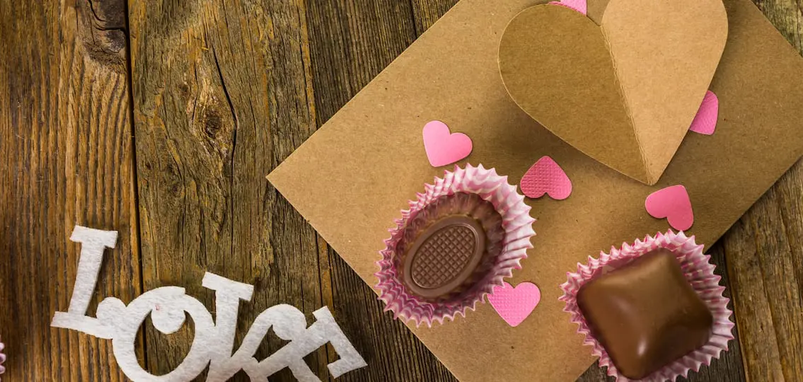 Hand crafted Valentines Day card from recycled paper with chocolates.
