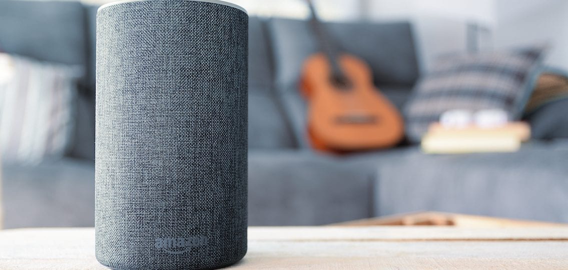 amazon alexa on a coffee table with a blurred living room in the background