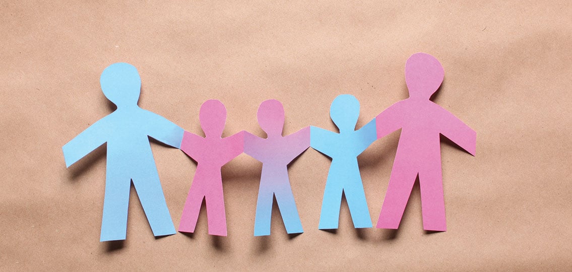 paper Family holding hands, two pink, two blue, and one with a pink to blue gradient