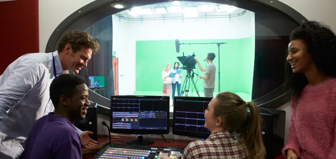 Teens learning how to film in a film studio