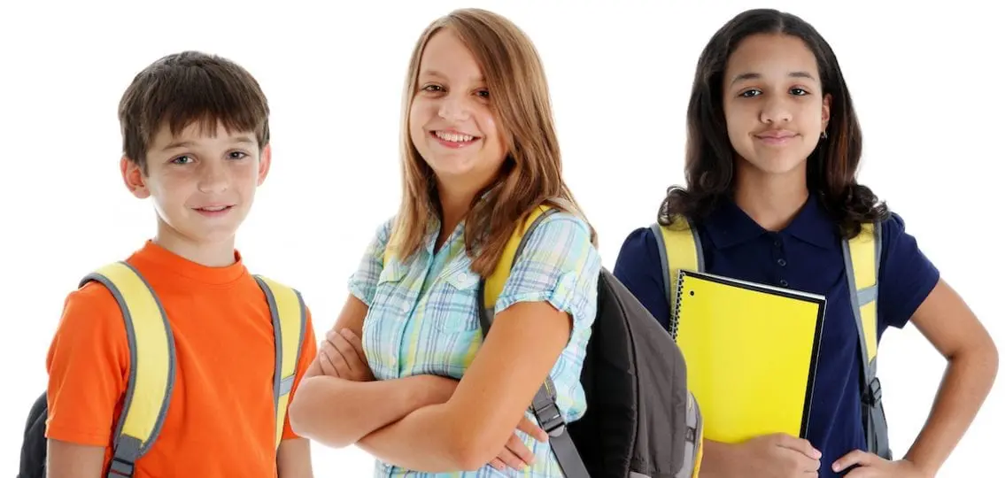 Middle schoolers ready for class smiling on white background