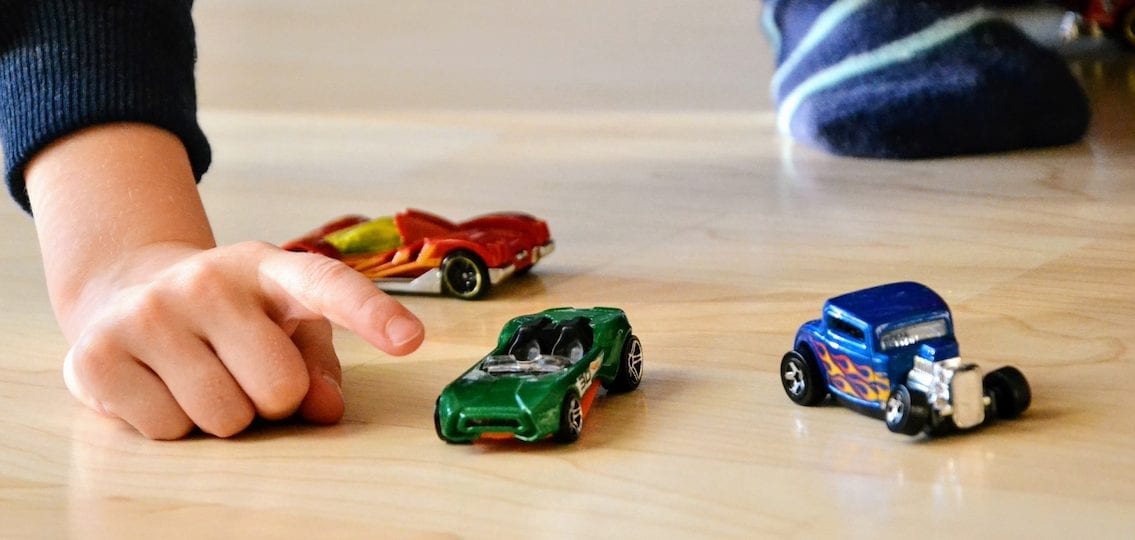 close up Boy with toy cars of different colors