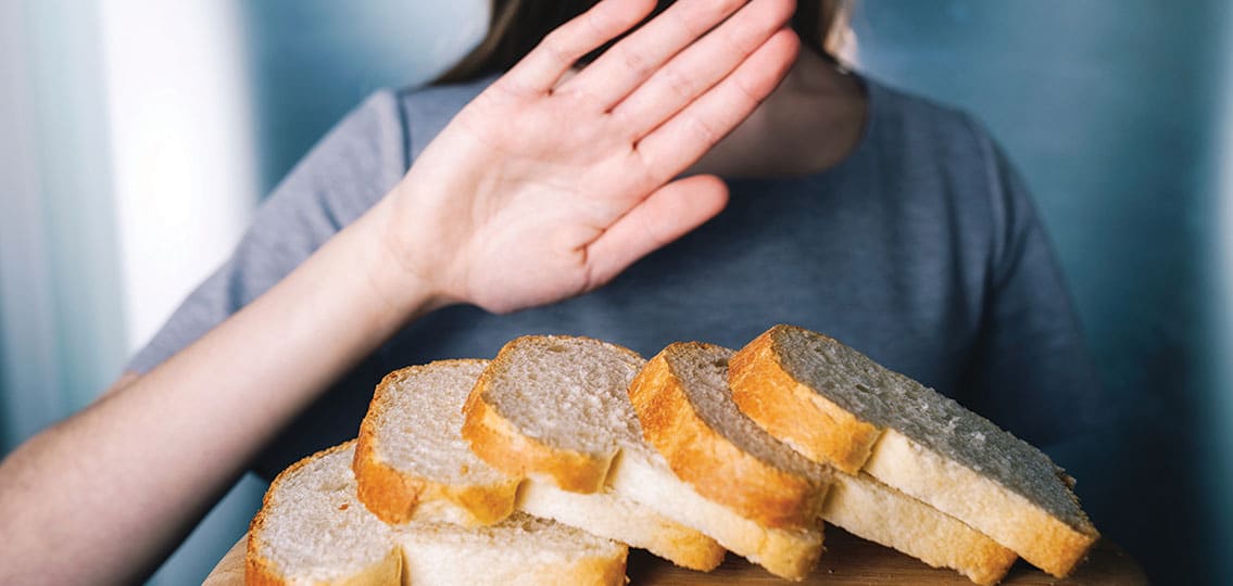 Gluten Intolerance Concept. Young Girl Refuses To Eat White Bread