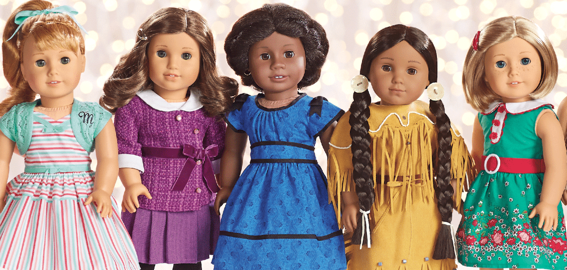 American Girl Dolls posing in front of lights