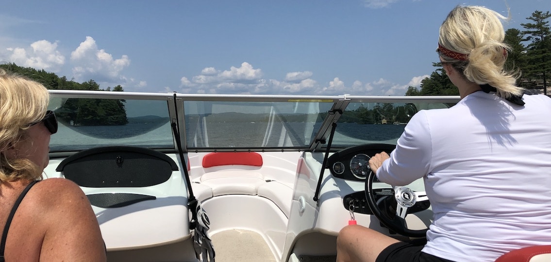 Moms driving a boat on a trip to new hampshire
