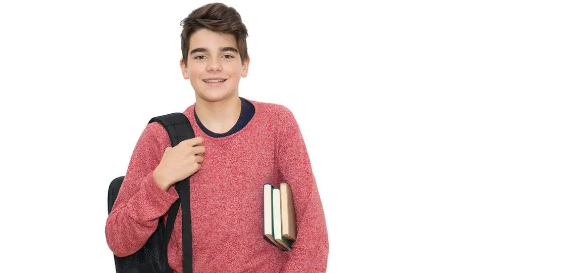 Average student with a shoulder backpack and books smiling
