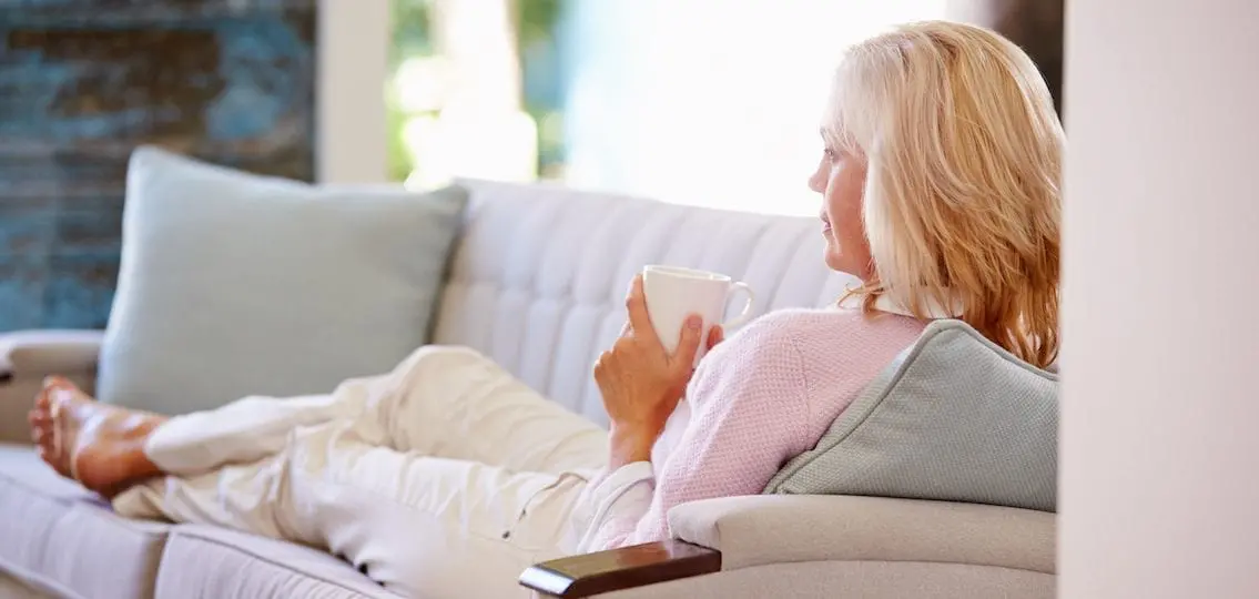 Mom drinking coffee on a couch