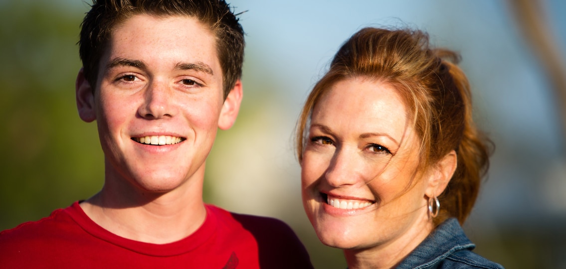 Mom with her freshman teen son smiling