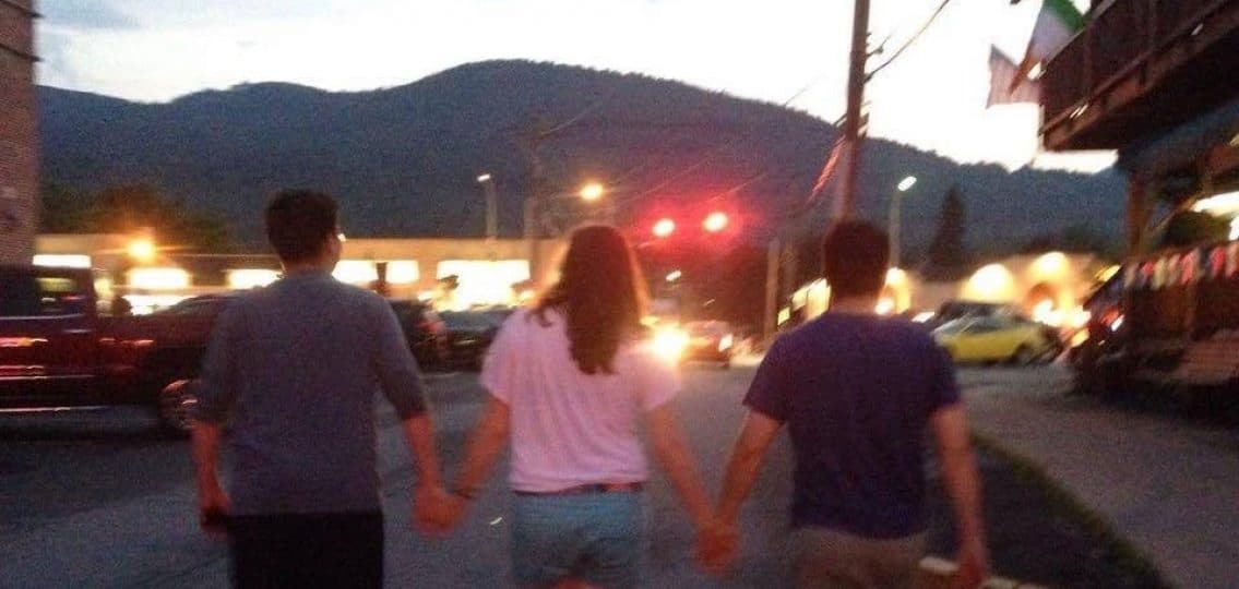 Family photo teens holding hands and walking blurred away from camera