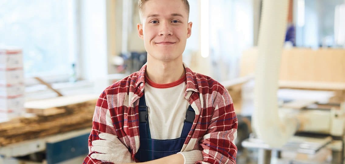 Confident Carpentry Student In Work Gloves