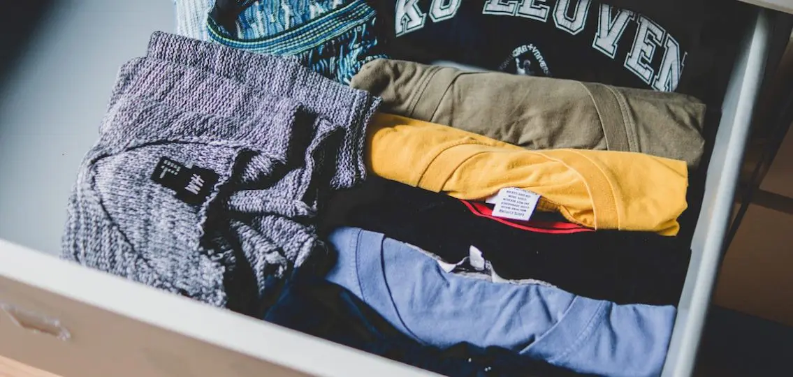 folded organized shirts in a dresser drawer