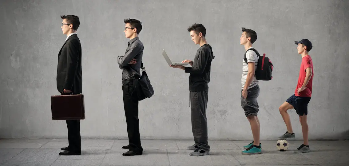 a boy growing up getting taller wearing more adult-like clothes from left to right