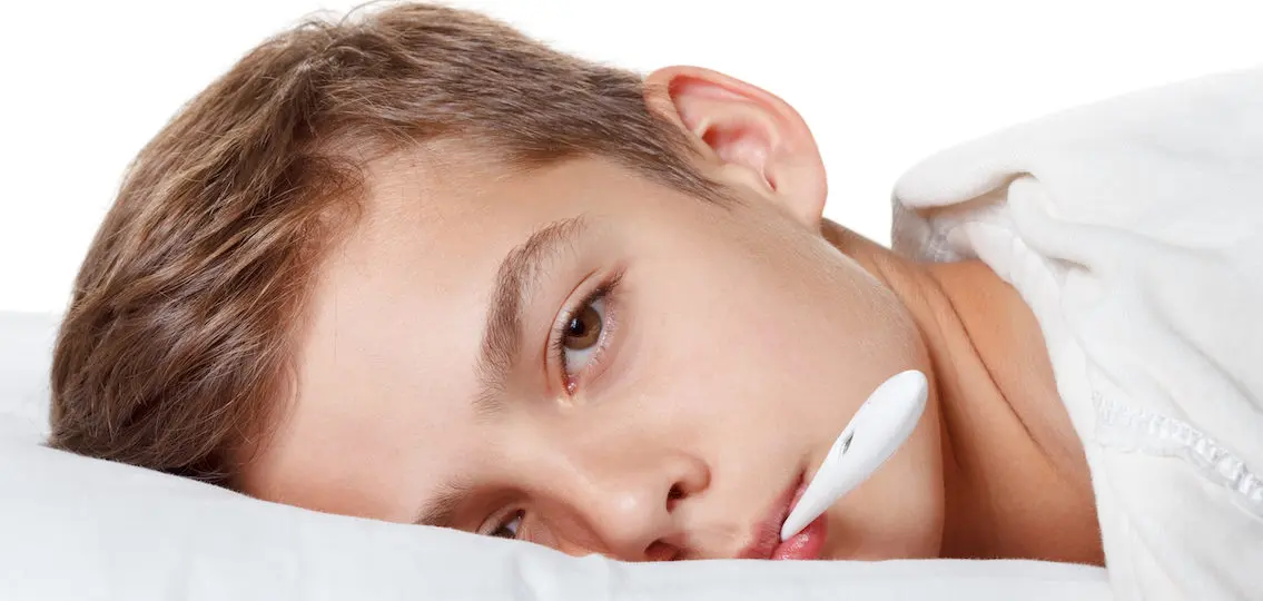 Teen Boy with the flu and thermometer preparing for treatment procedures