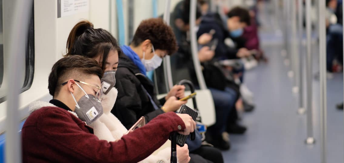 subway in singapore full of people wearing face masks