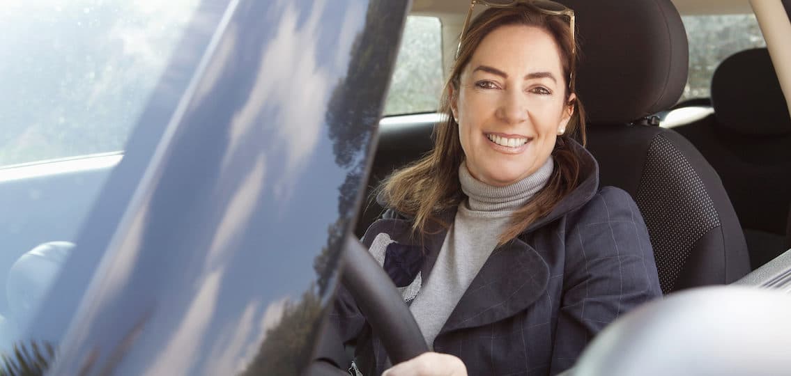 mom smiling and waiting in a car