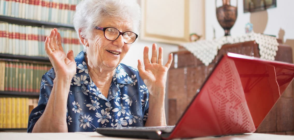 older woman looking surprised and happy trying to install zoom