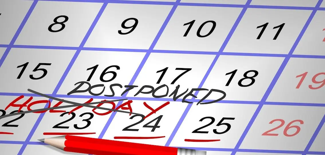 calendar with the word holiday crossed off with the word postponed
