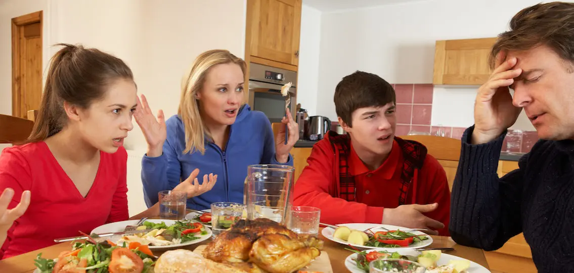 angry family yelling at father over dinner in kitchen