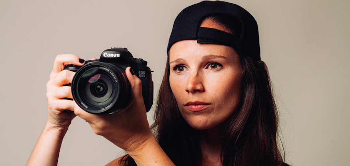 headshot Sarah Moshman holding canon camera