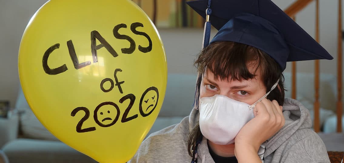 teenager in face back with a balloon reading class of 2020
