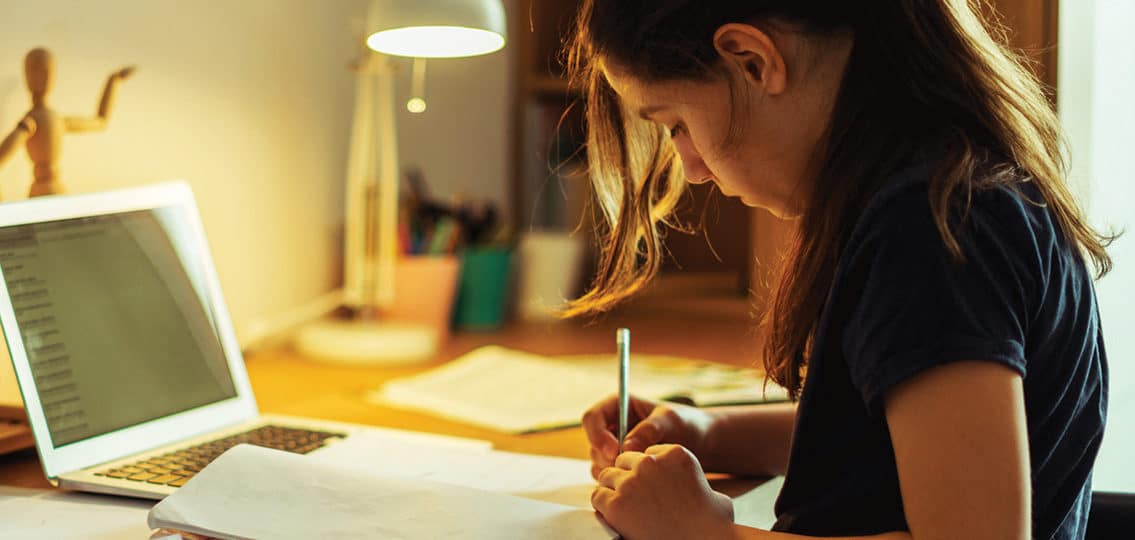 Teenager girl doing homework online for online classes