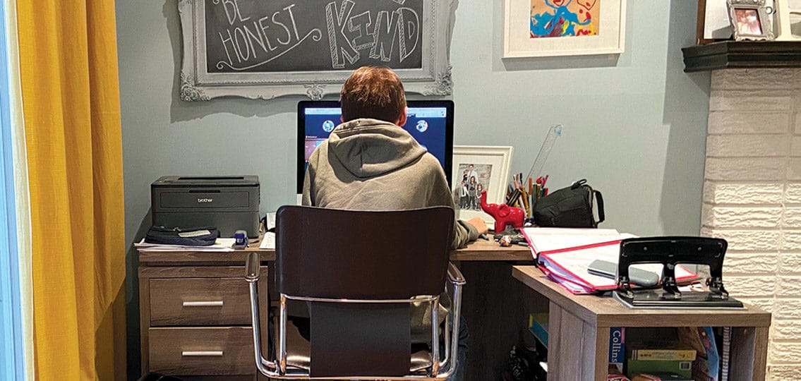 teen boy working from home in his own little office