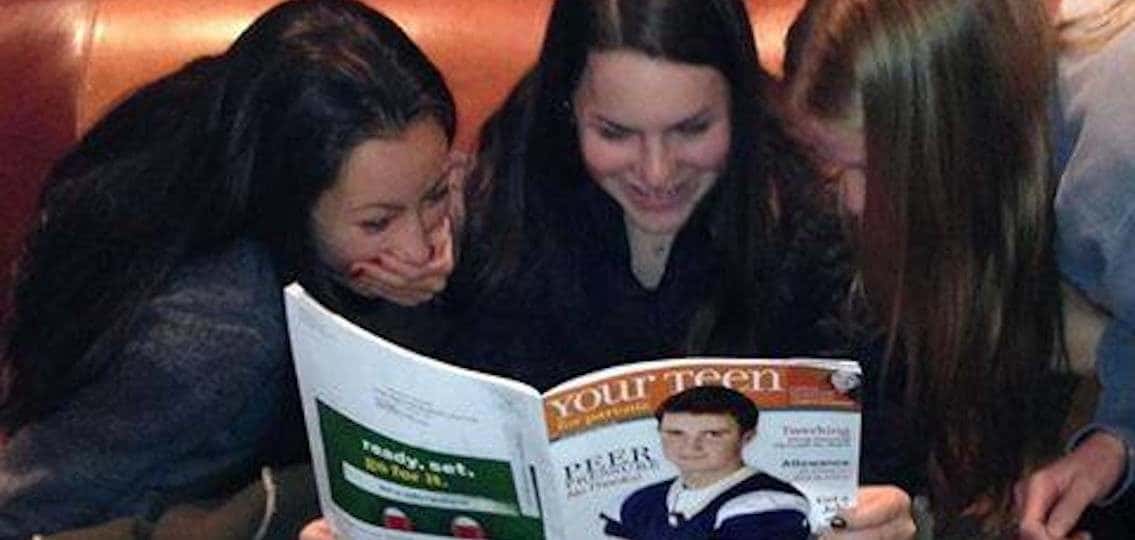 three teen girls reading Your Teen Magazine and laughing