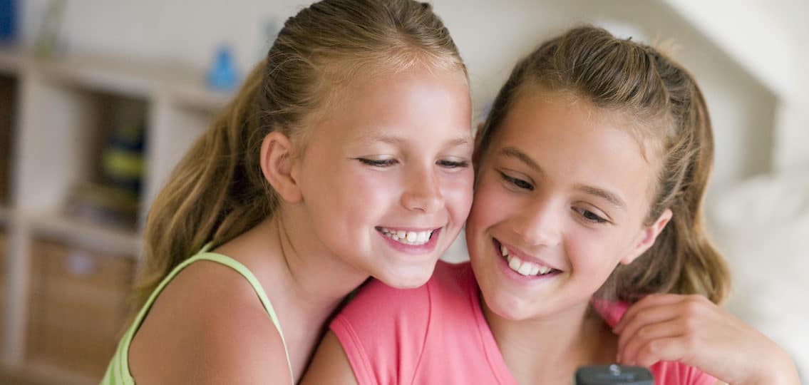 two tween eleven year old girls hugging and posing