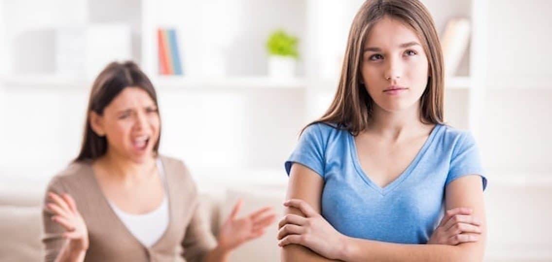 tough love parenting, mom yelling at angry daughter ignoring her crossing her arms
