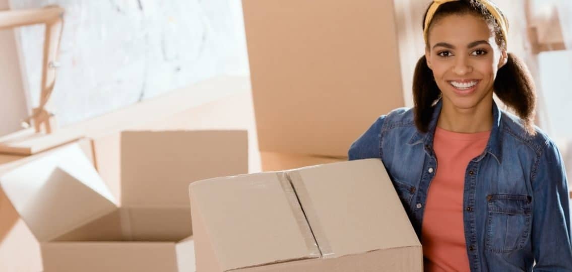 Teen girl with moving boxes getting ready to leave for college