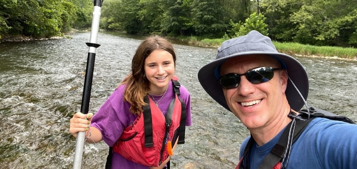 Author David Rockower and daughter smiling on a canoeing trip