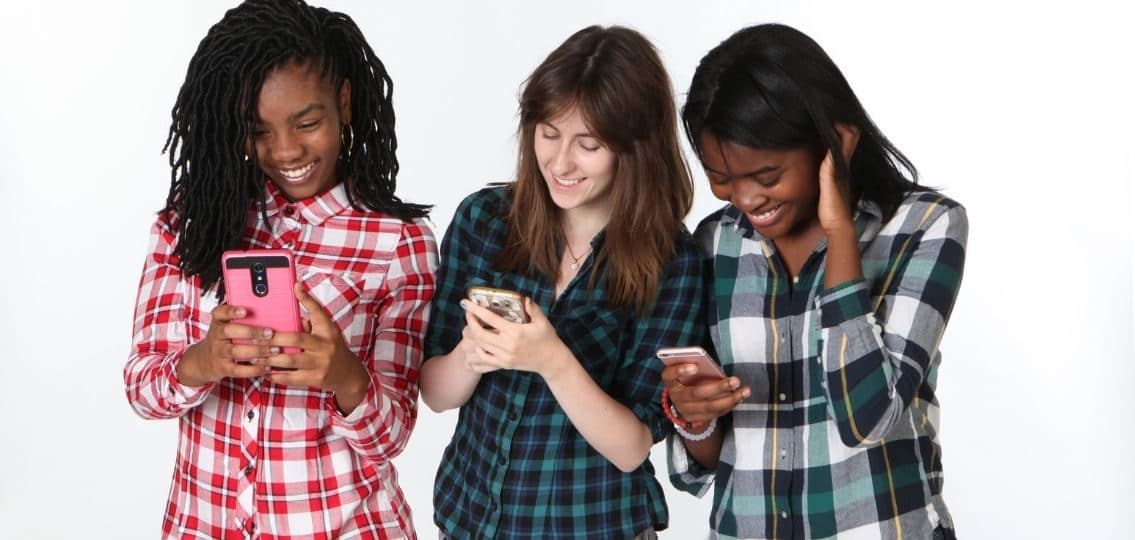 Teens using technology phones
