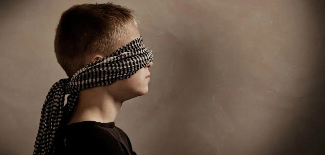 young teen boy blindfolded serious high school hazing concept
