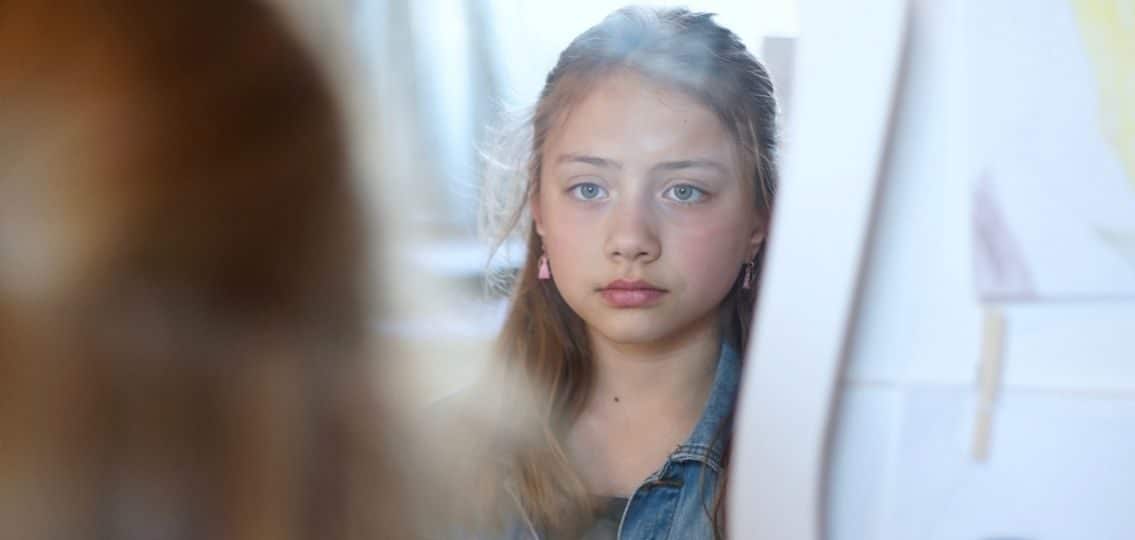 girl looking in mirror disliking her body eating disorder