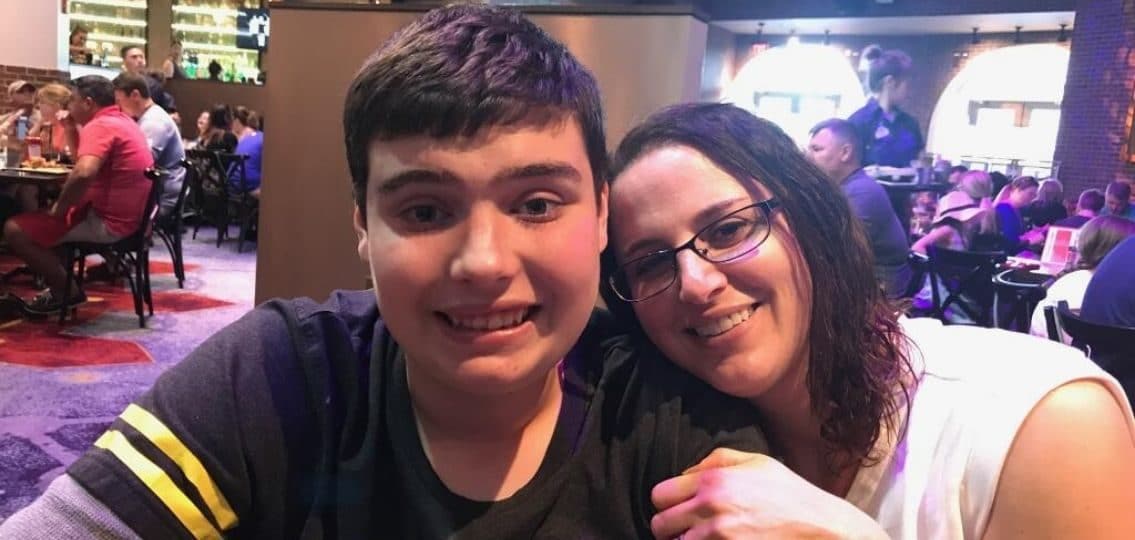 the author taking a selfie with her autistic son in a restaurant