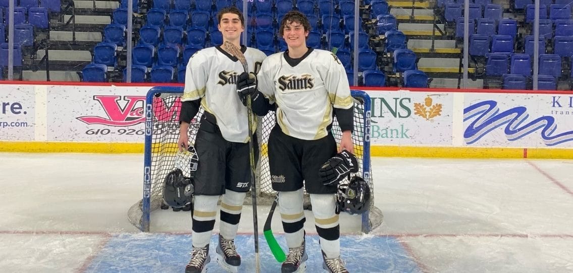 the two brothers on an ice hockey rink