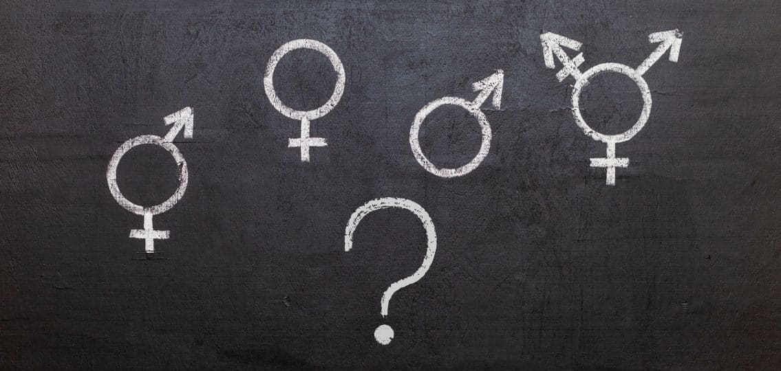 symbols for gender written on a chalk board with question mark underneath questioning