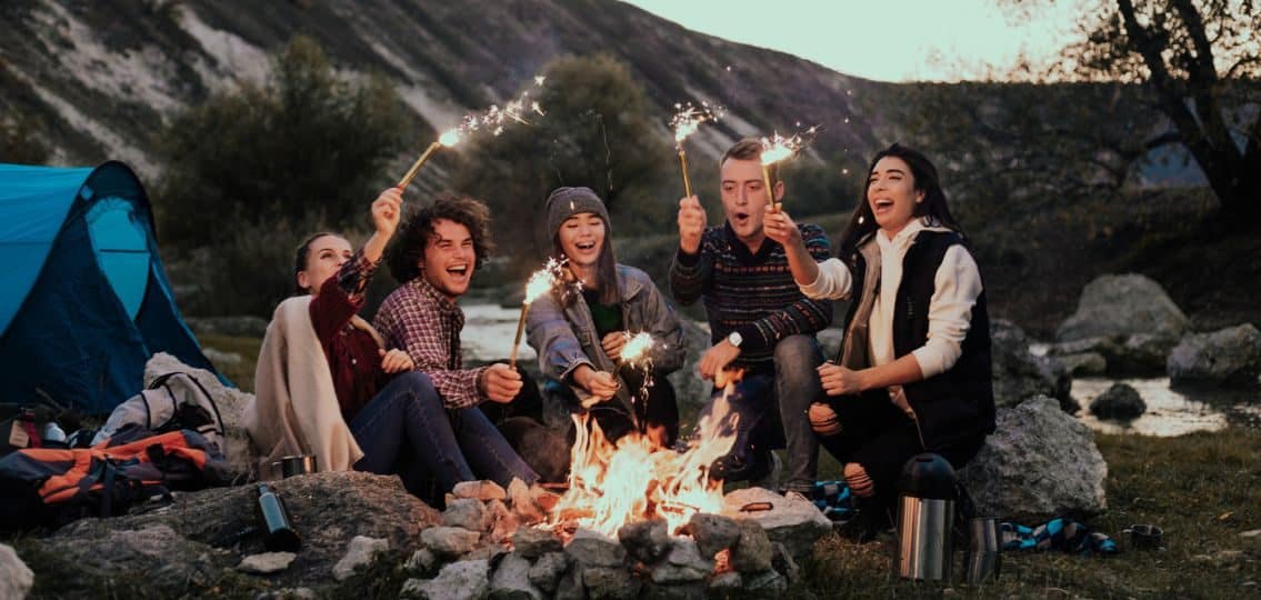 teens sitting around a campfire