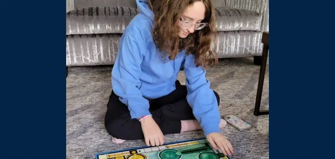 teen girl playing the classic family board game sorry