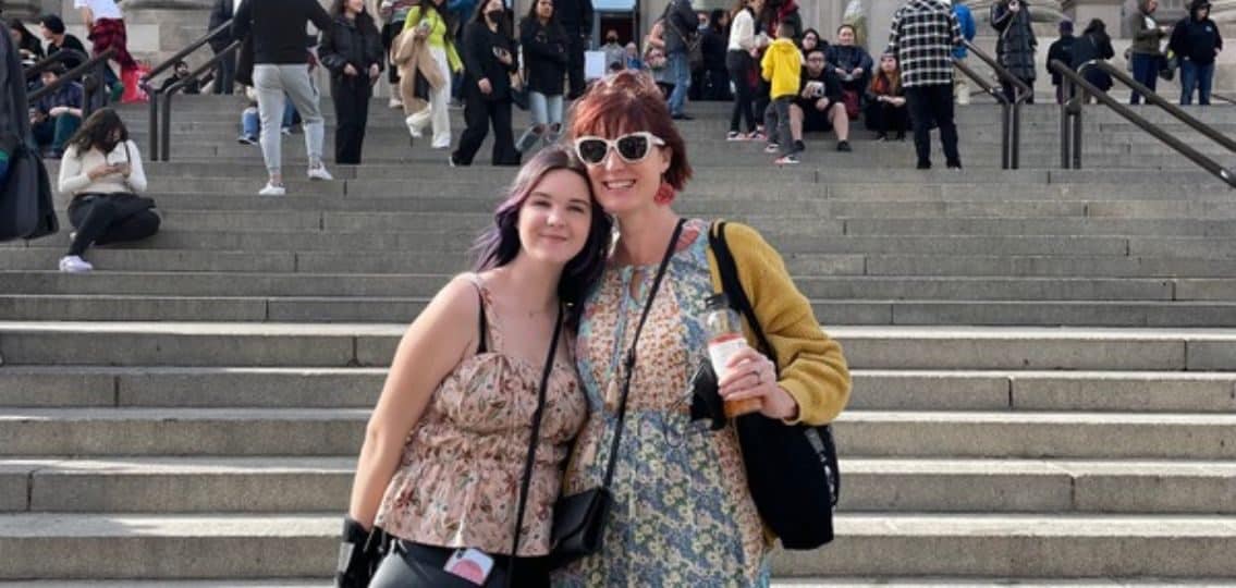 The author with her daughter outside some stairs telling her mom story