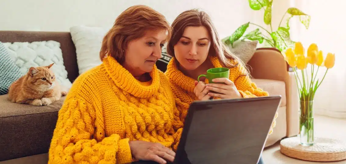 A mom posting on college decision day while her daughter watches