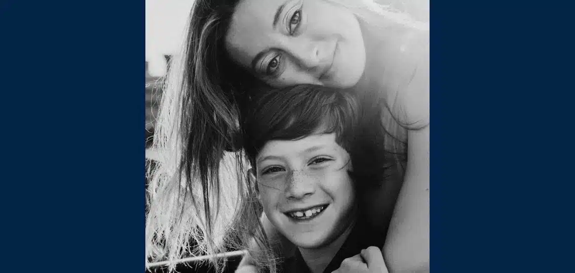 Author and her son in black and white smiling together and hugging