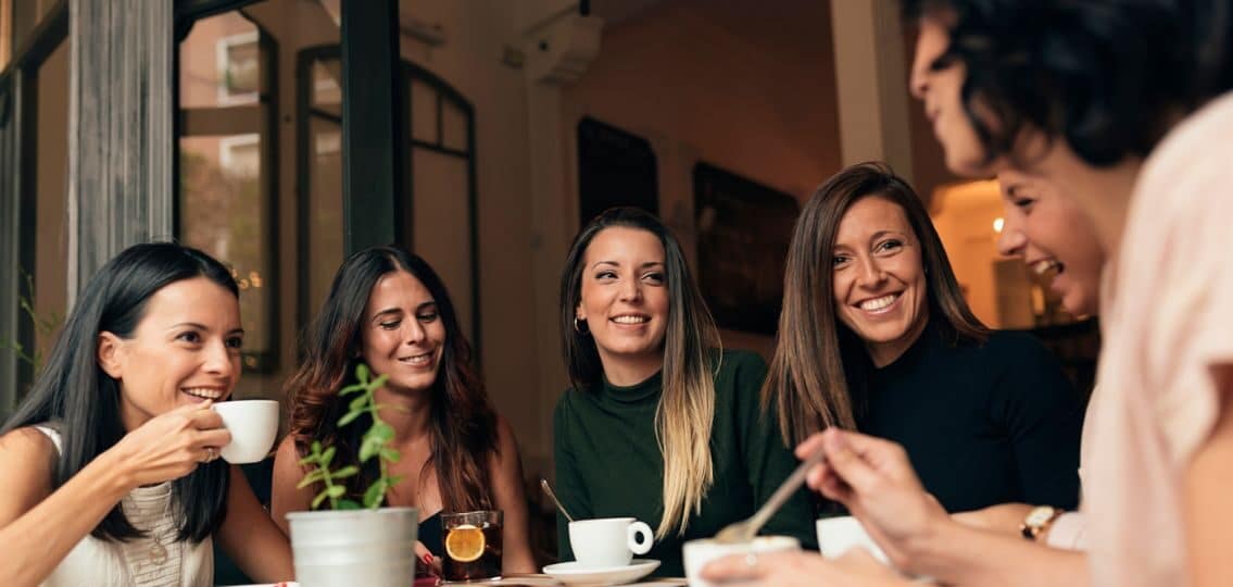 A mom clique out for coffee smiling