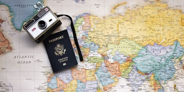 Grad trip idea camera and passport on a map