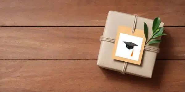 A graduation present with a graduation cap on the card