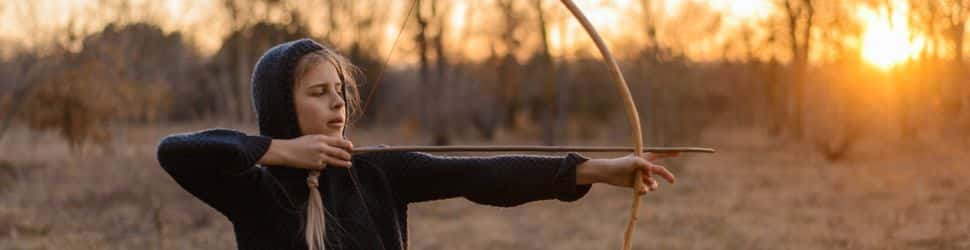 a teenage girl doing archery as a hobby